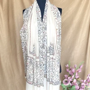 Handwoven bone white cashmere scarf, displayed on a mannequin.