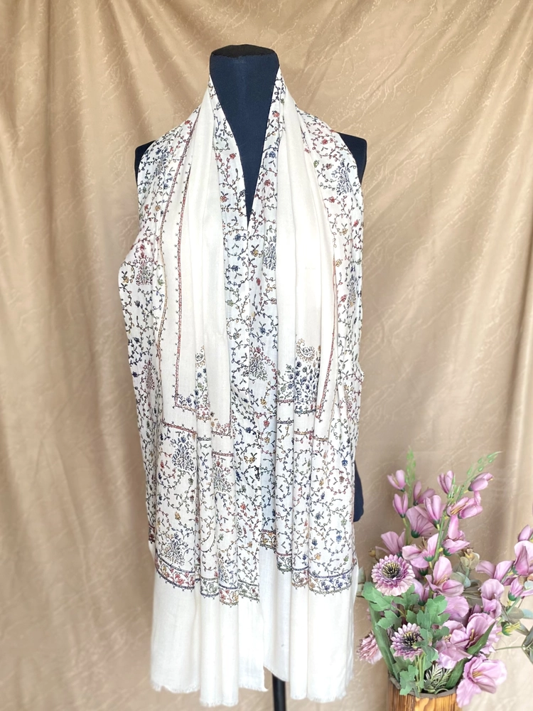 Handwoven bone white cashmere scarf, displayed on a mannequin.