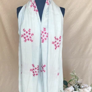 Handwoven ice blue cashmere scarf with intricate multicolored embroidery, displayed on a mannequin.