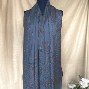 Handwoven charcoal grey cashmere scarf with intricate multicolored embroidery, displayed on a mannequin.