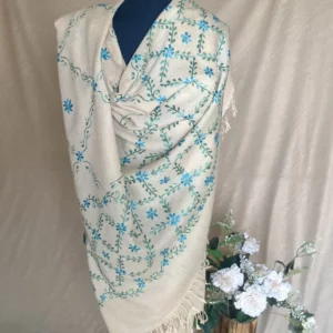Handwoven cream blue-green cashmere shawl, displayed on a mannequin.