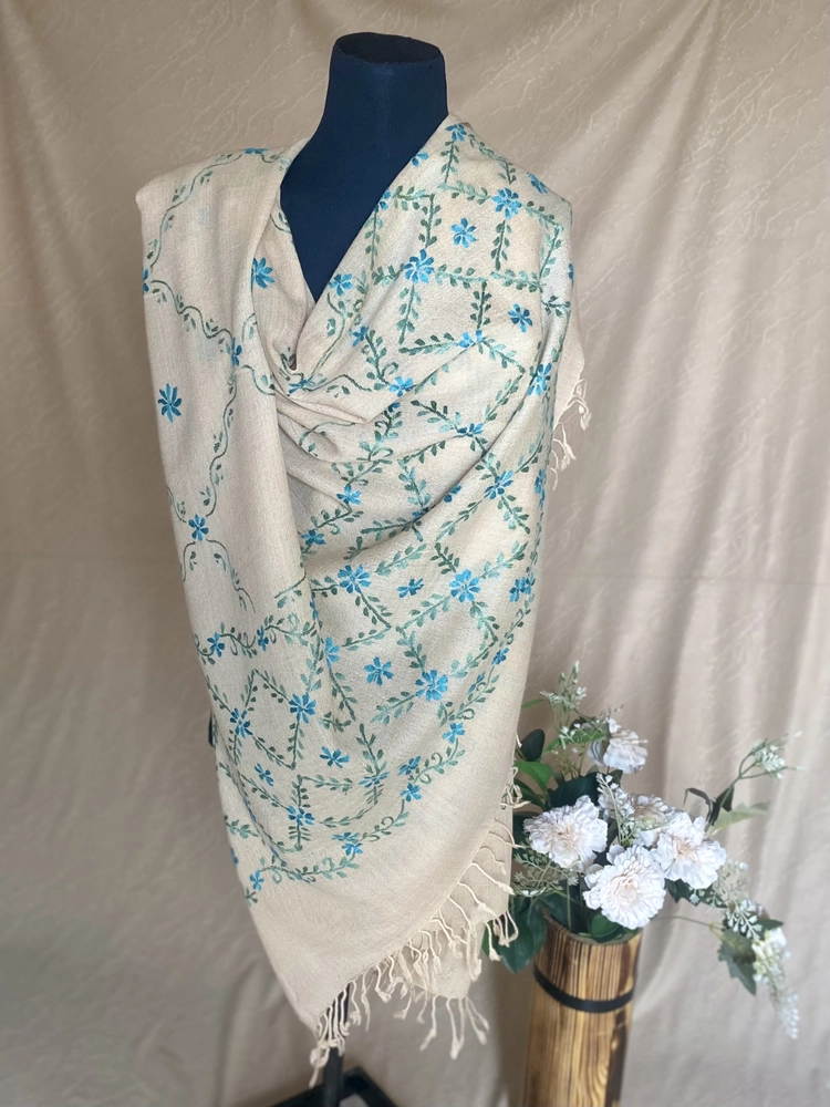 Handwoven cream blue-green cashmere shawl, displayed on a mannequin.