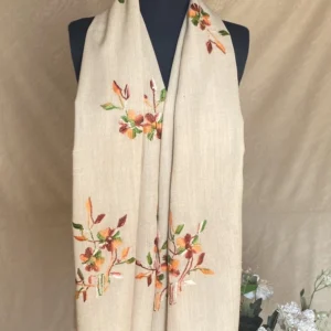Handwoven cream floral cashmere scarf, displayed on a mannequin.