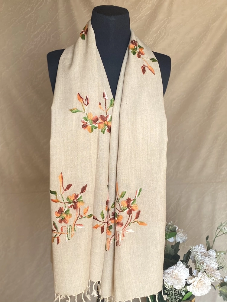 Handwoven cream floral cashmere scarf, displayed on a mannequin.
