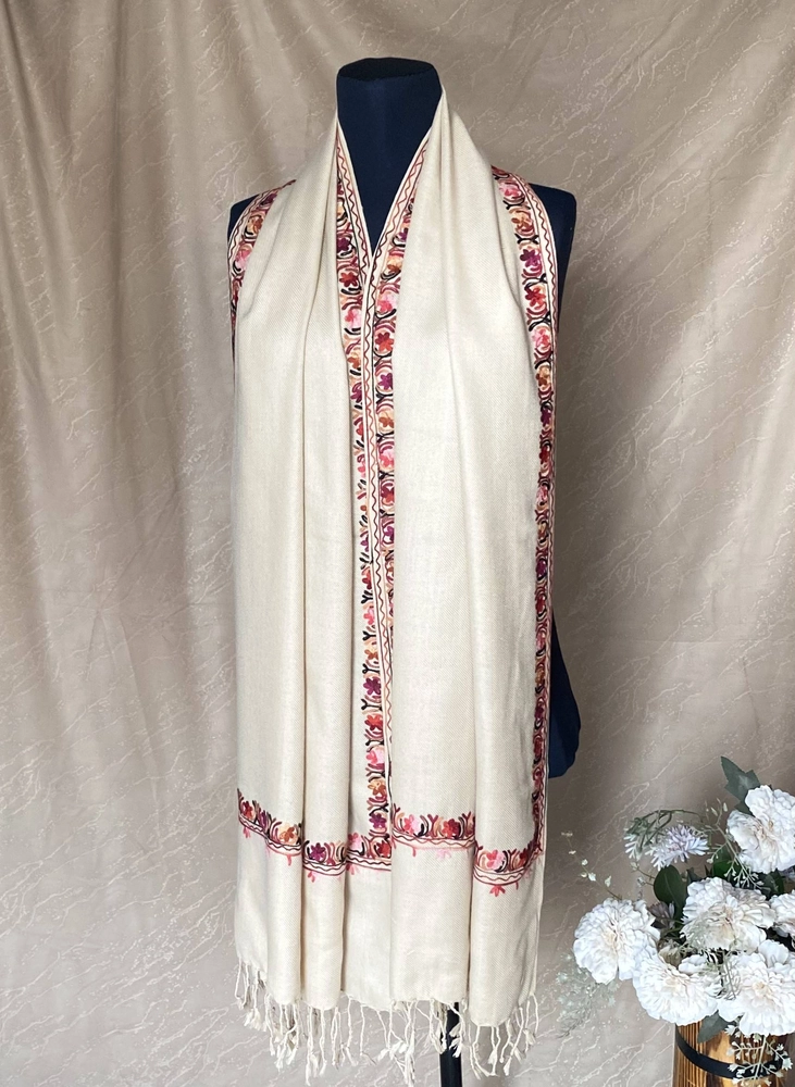 Handwoven creamy beige cashmere scarf, displayed on a mannequin.