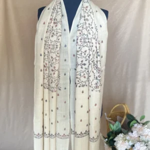 Handwoven creamy white cashmere scarf, displayed on a mannequin.
