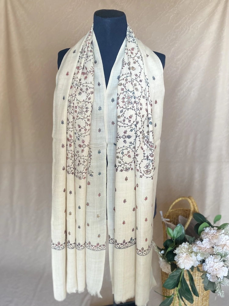 Handwoven creamy white cashmere scarf, displayed on a mannequin.
