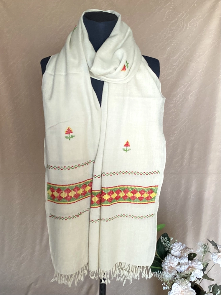 Handwoven creamy white cashmere shawl, displayed on a mannequin.