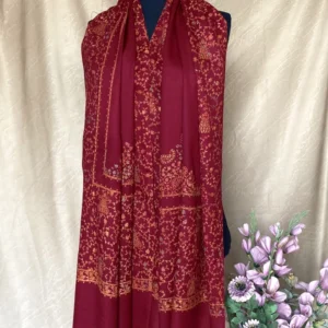 Handwoven deep red cashmere scarf, displayed on a mannequin.