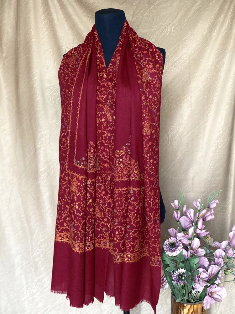 Handwoven deep red cashmere scarf, displayed on a mannequin.