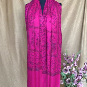 Handwoven fuchsia pink cashmere scarf, displayed on a mannequin.