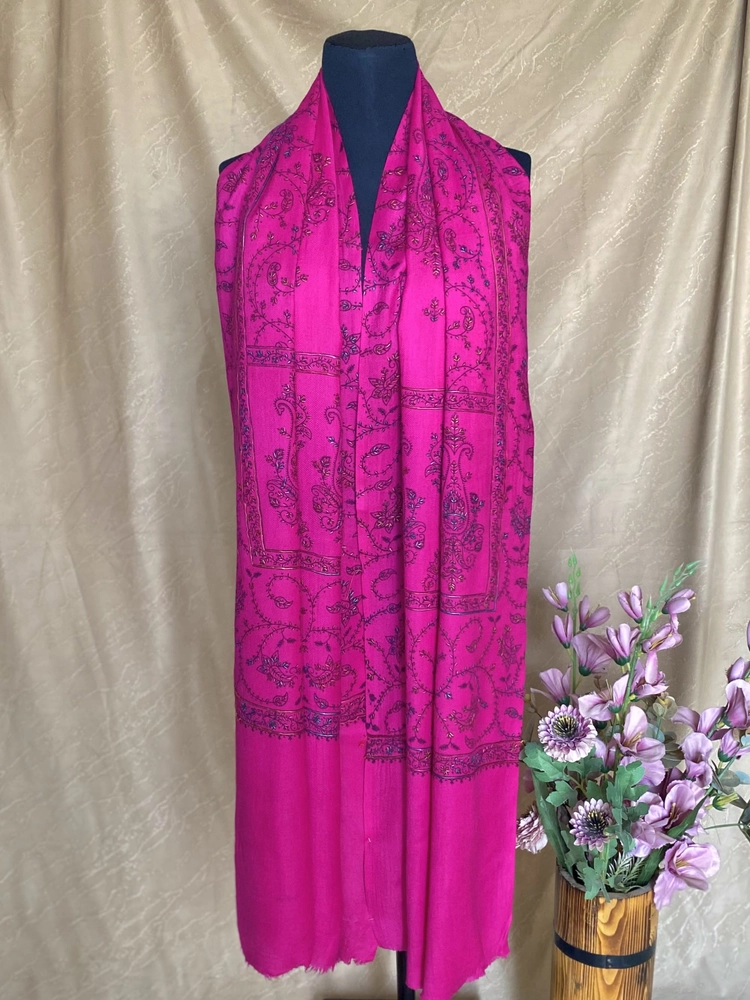 Handwoven fuchsia pink cashmere scarf, displayed on a mannequin.