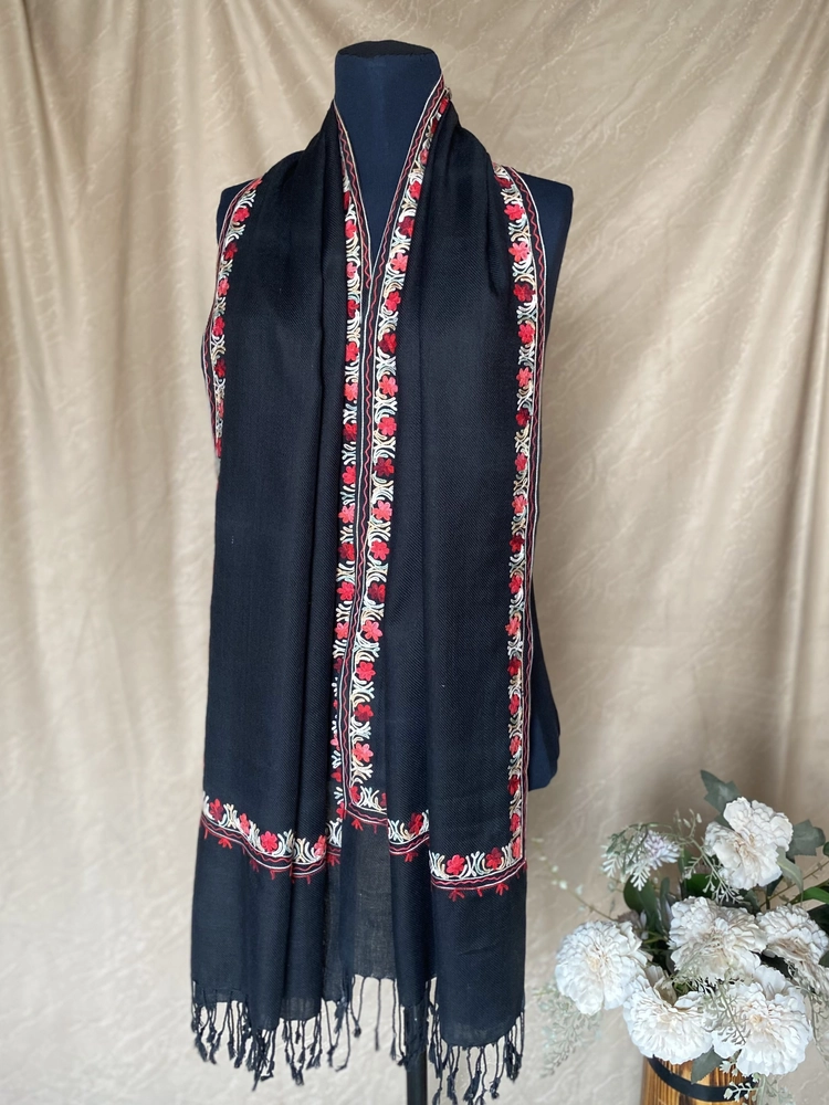 Handwoven jet black cashmere scarf, displayed on a mannequin.