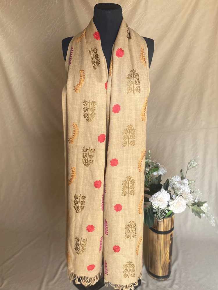 Handwoven light brown cashmere shawl with intricate multicolored embroidery, displayed on a mannequin.