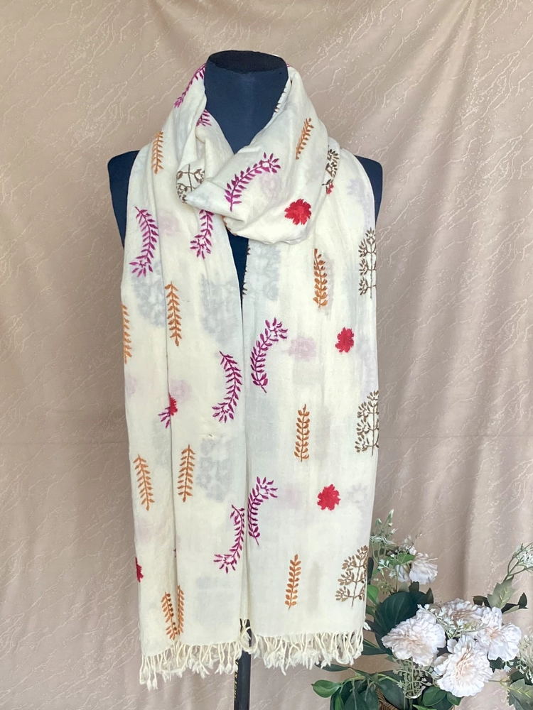 Handwoven off-white cashmere shawl with intricate multicolored embroidery, displayed on a mannequin.