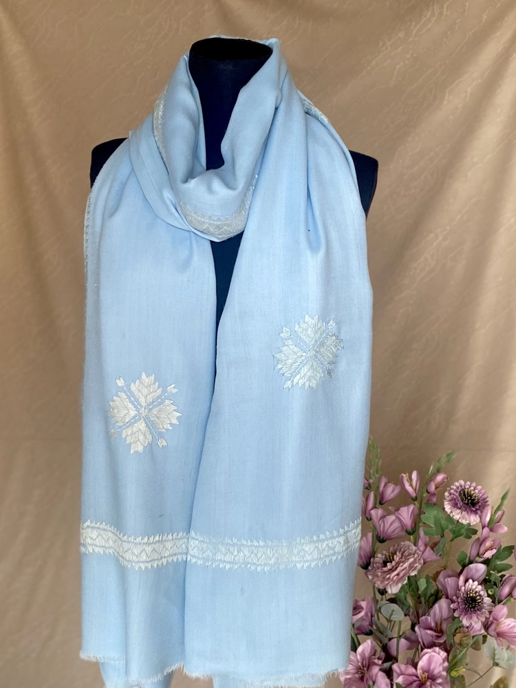 Handwoven sky blue cashmere shawl, displayed on a mannequin.